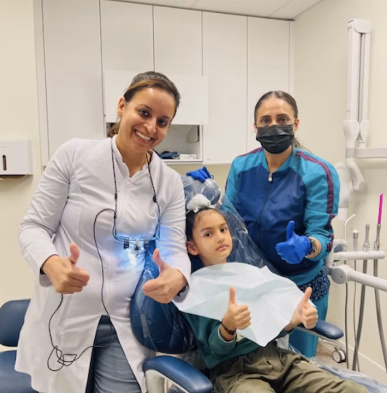 Saravpreet Kaur with the Dazzle Dental care team